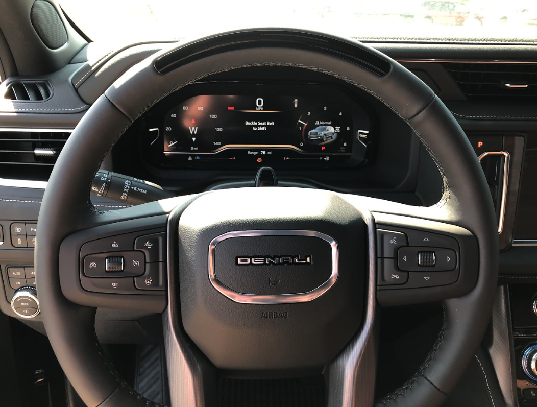 Close-up of the Denali steering wheel and Super Cruise driver display in a GMC vehicle at Crain Buick GMC in Springdale